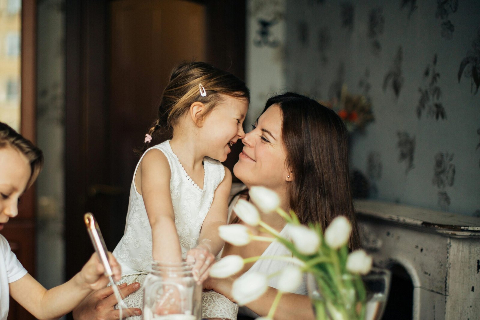 A joyful moment of a mother baking with her children in a cozy home environment.